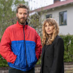 En man och en kvinna står framför en villa.