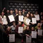 Gruppbild på glada personer med prisdiplom.